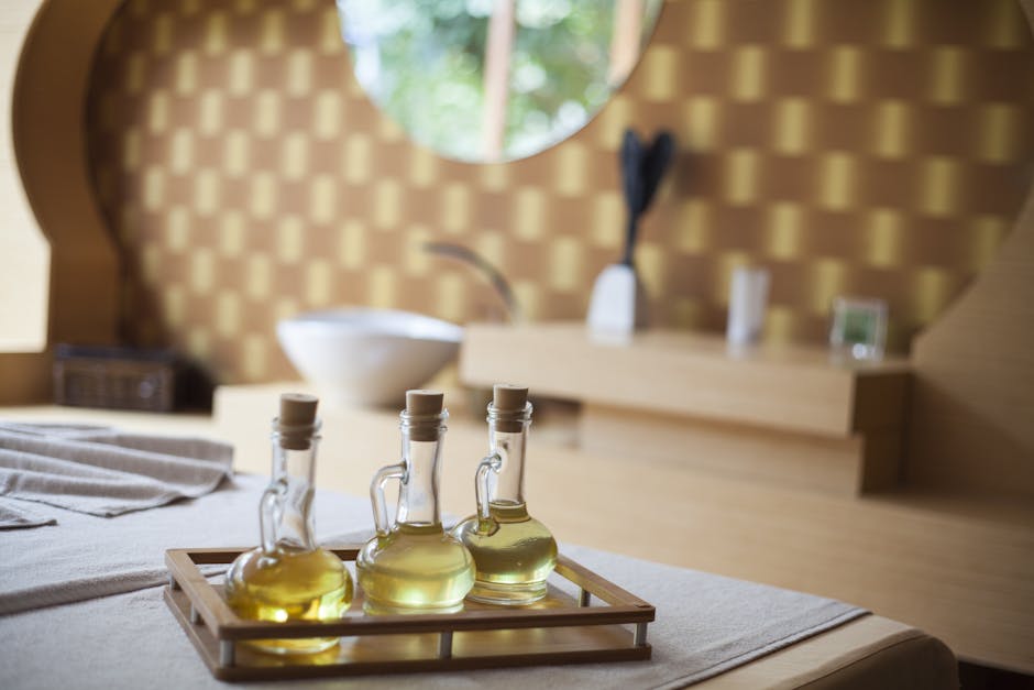 Elegant indoor spa room with natural oil bottles on a wooden tray, exuding relaxation